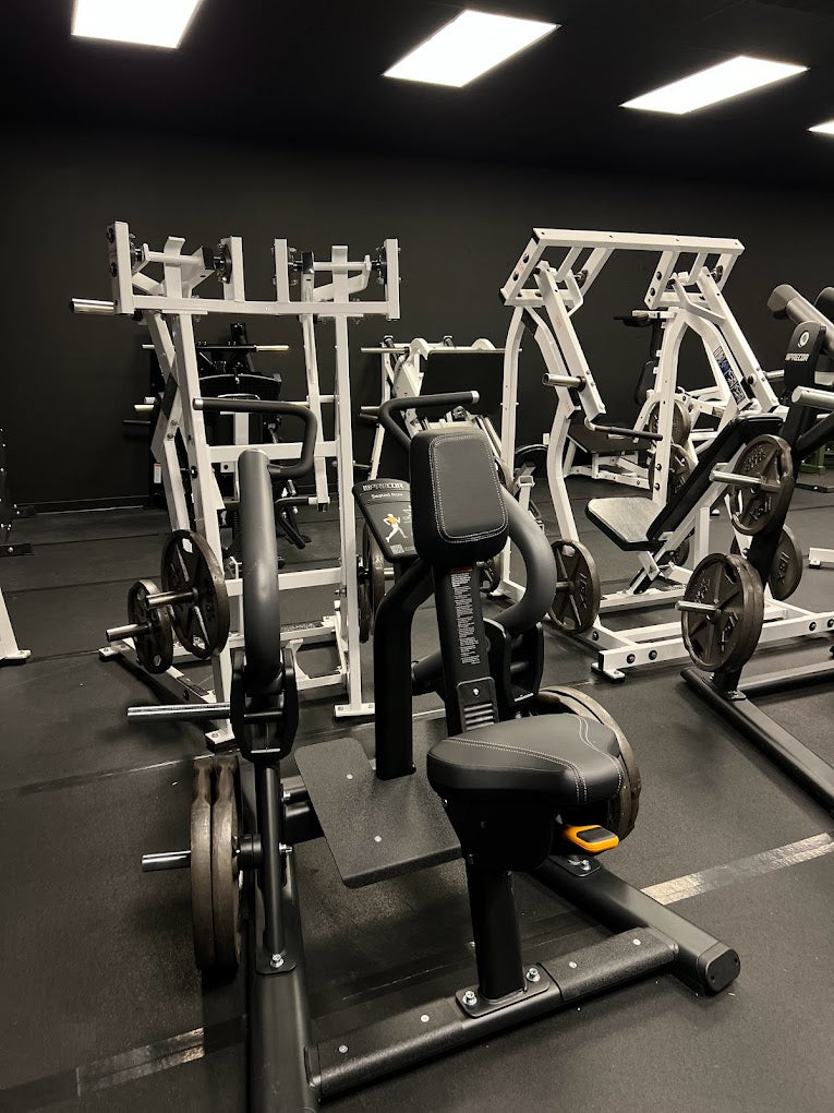 White plate-loaded strength machines and a seated row