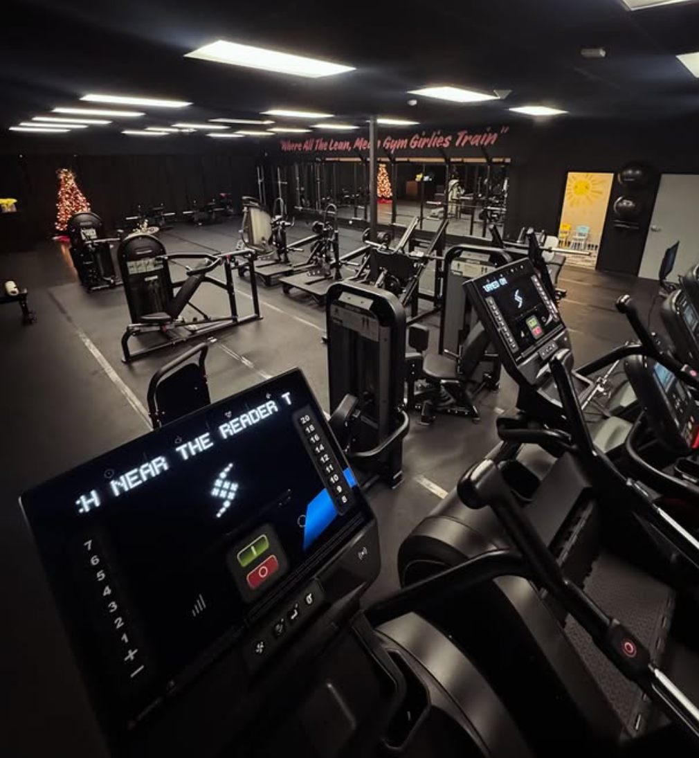 Wide view of the Manzo Fitness floor with cardio machines in front and strength machines behind