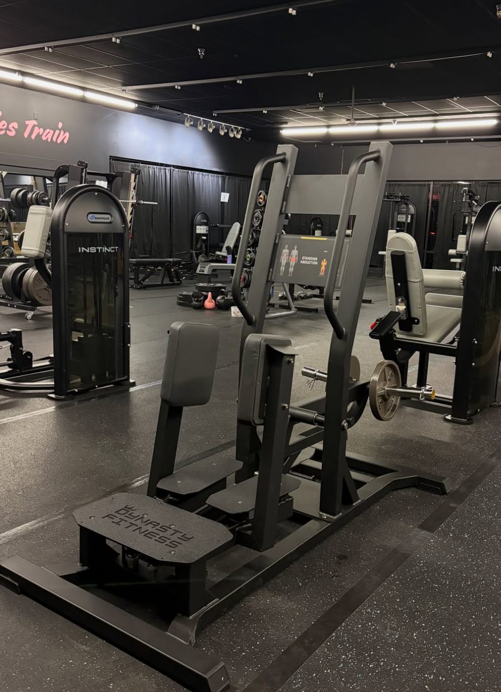 Hip abduction machine with Nautilus strength stations on either side