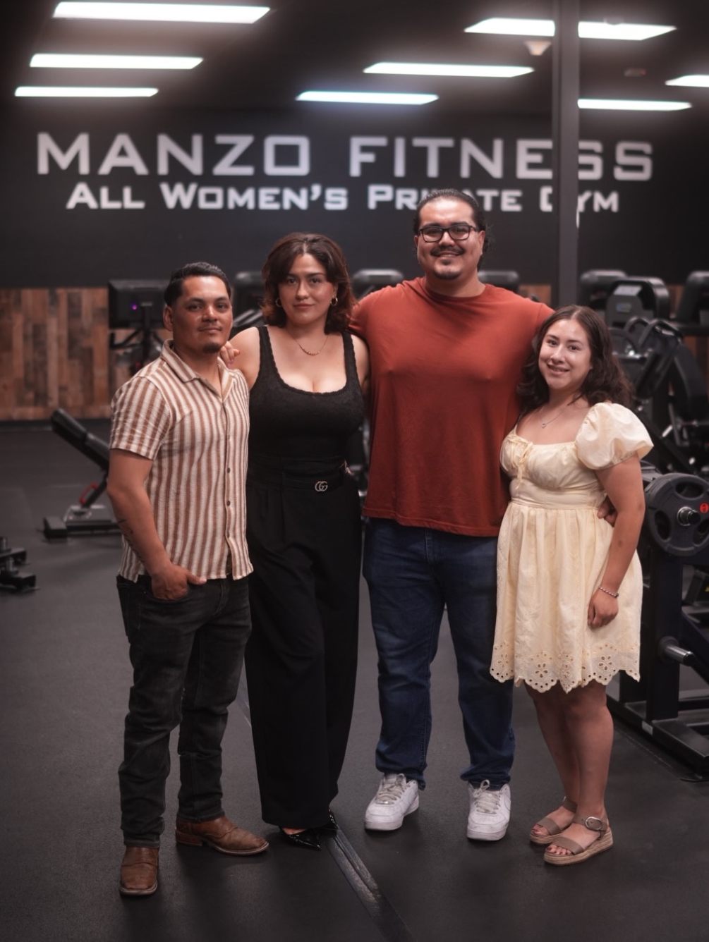 The Manzo Fitness team standing together on the gym floor